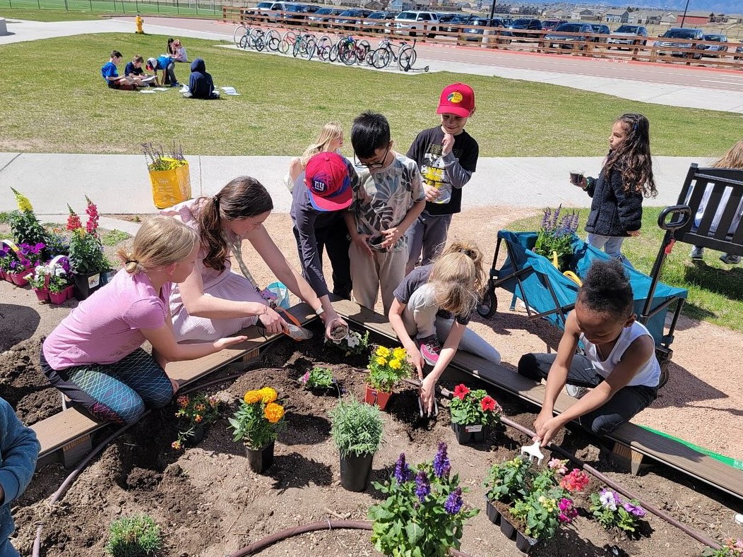 a group of students gardening outside of LPES